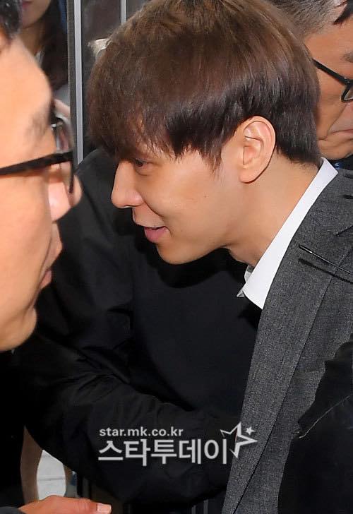 Surrounded by many people, the singer still smiled.