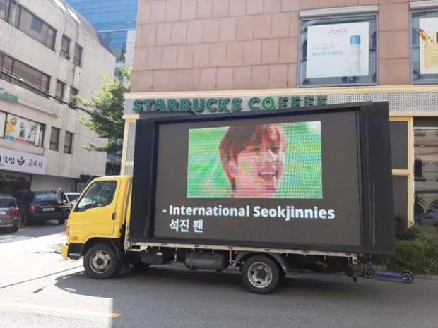 Jin's international fans sent a protest truck demanding Big Hit Entertainment to treat the idol better
