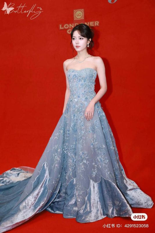 Zhao Jinmai viral close-upwoman-gown-redbackground-portrait.