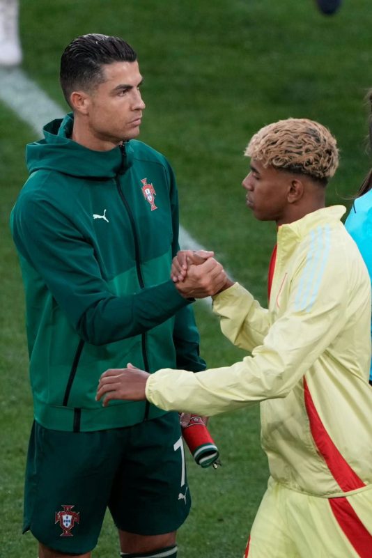 Yamal better than CR7soccer' 'players' 'handshake' 'green' 'jacket.