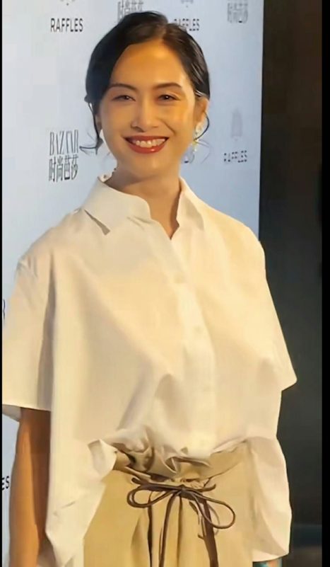 Athena Chu braless outfitwoman' 'smiling' 'white' 'hirt' 'tan' 'ants.