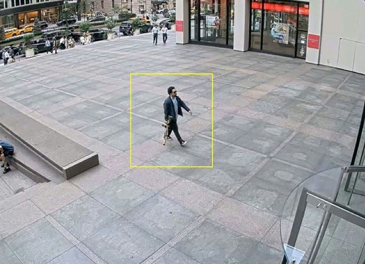 Manhattan skyscraper shootingman' 'rifle' 'walking' 'outdoor.