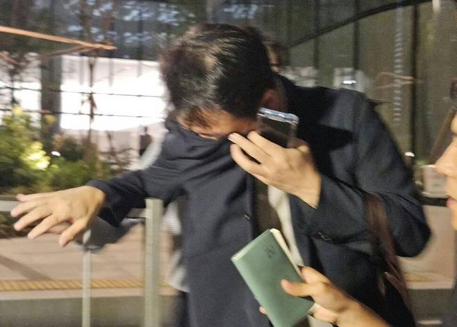 Kim Jin‑woo necklace concealment investigationman' 'suit' 'phone' 'crying.