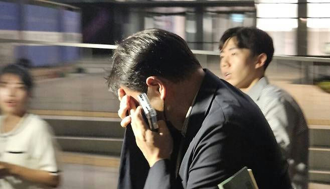 Kim Jin‑woo necklace concealment investigationman' 'phone' 'distressed' 'outdoors.