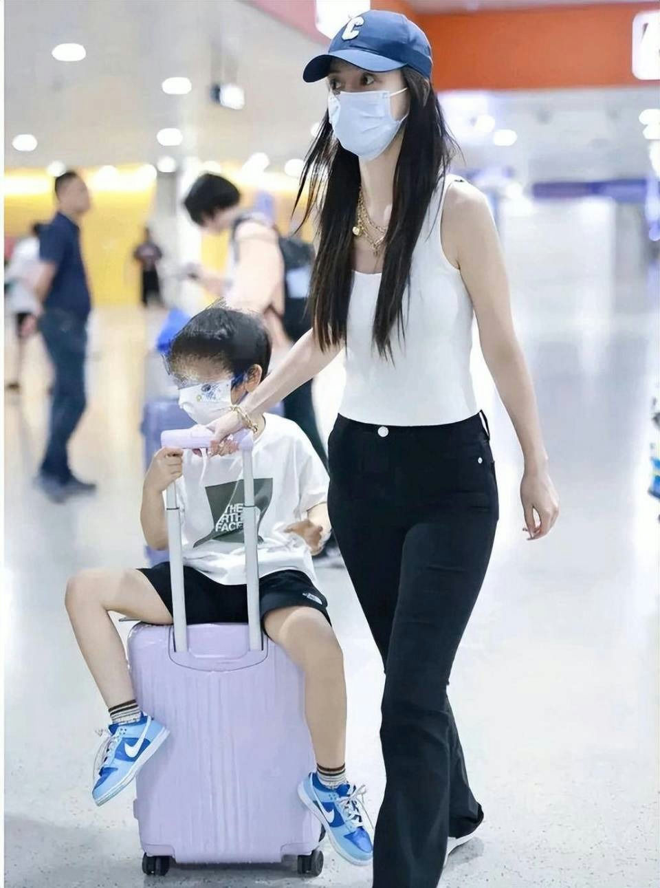 Angelababy Huang Xiaoming post-divorce dramapeople' 'airport' 'mask' 'suitcase' 'fashion.