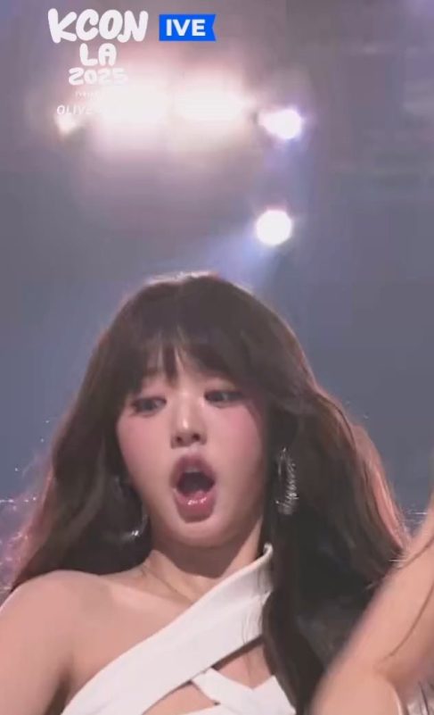 Jang Wonyoung mic drop viral KCONperson' 'winking' 'white' 'outfit' 'brunette' 'hoop' 'earring.