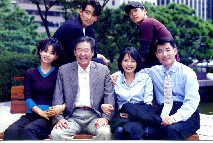 highest-rated Korean dramasgroup' 'smiling' 'outdoors' 'sitting' 'bench.