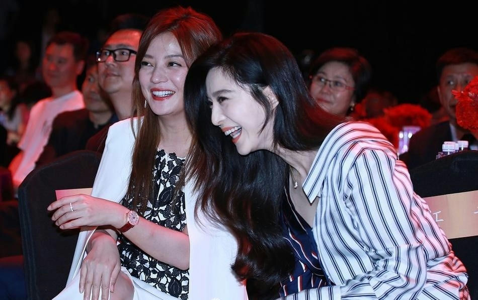 Zhao Wei vs Fan Bingbingtwo' 'smiling' 'audience' 'formalwear' 'blouse' 'laughing.