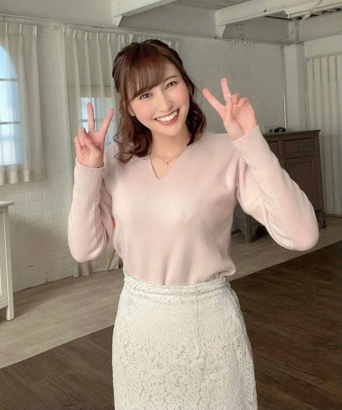 Honda Hitomi retirementwoman' 'smiling' 'peace' 'sign' 'pink' 'sweater' 'white' 'skirt.