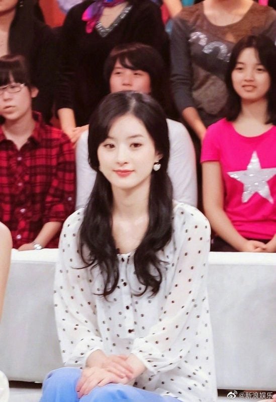 Zhao Liying Dior ambassadorpeople' 'audience' 'actress' 'seated' 'smiling' 'ponytails.