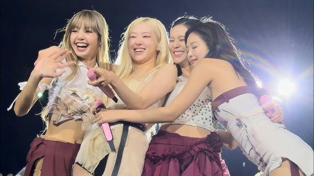 BLACKPINK fake Shein merchandisepeople' 'four' 'smiling' 'hugging' 'holding' 'microphones' '' '.