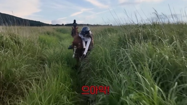 Kwon Yuri horseback riding fall' '' 'horseback' 'riding' 'grass' 'field' 'mountain.