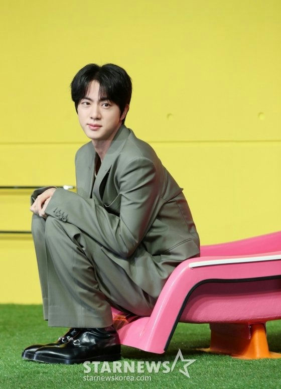 BTS Jin brand reputation August 2025person' '' 'in' 'suit' 'pinkchair' 'yellowbackground.