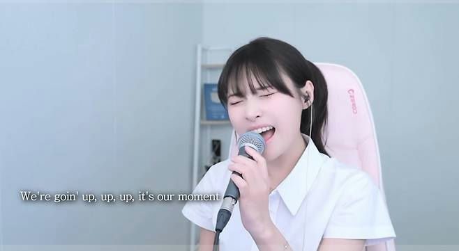 Golden cover challengeperson' 'singing' 'microphone' 'indoors' 'happy.