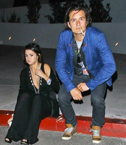 Selena Gomez Orlando Bloom scandal Taylor Swift Katy Perry feudpeople' 'sitting' 'street' 'cigarette' 'outdoors.