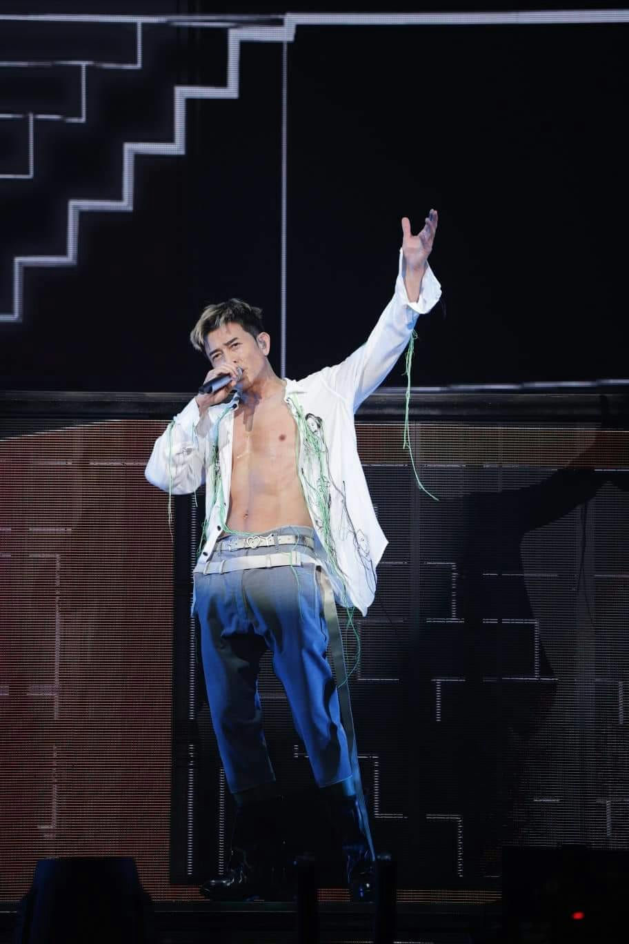 Chinese stage accidentsman' 'singing' 'shirtless' 'microphone' 'stage.