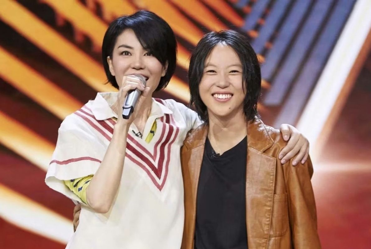 Cecilia Cheung and Faye Wong parenting stylestwo' 'women' 'singing' 'smiling' 'microphone' 'leather' 'jacket.