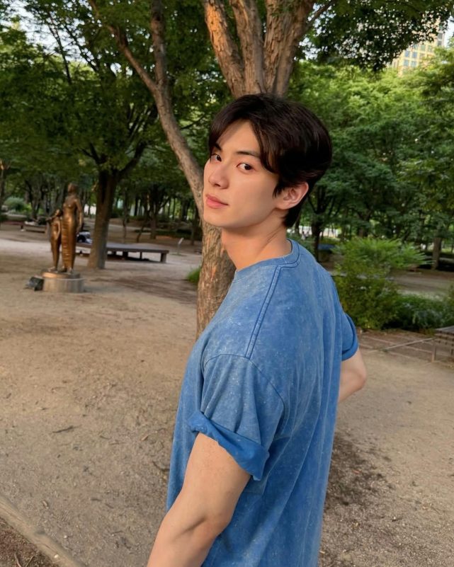 Lee Chae Min Bon Appétit, Your Majestyperson' 'park' 'blue' 'shirt' 'tree' 'statue.