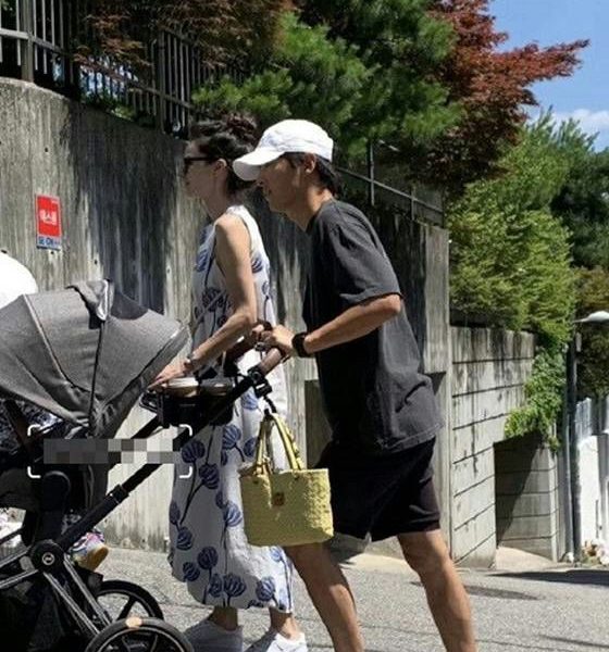 Song Joong-ki 40th birthday family updatepeople' 'stroller' 'walking' 'road' 'trees.
