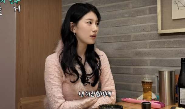 Suzy upper teeth flirting trendperson' 'table' 'eating' 'indoors' 'jacket.