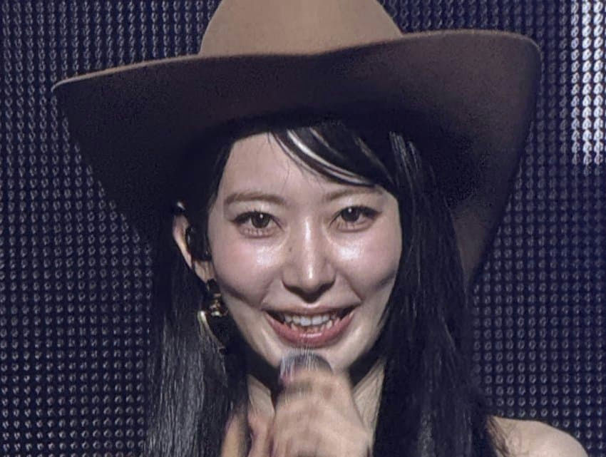 LE SSERAFIM Sakura unedited photosperson' 'woman' 'cowboy' 'hat' 'microphone' 'smiling' 'earrings.