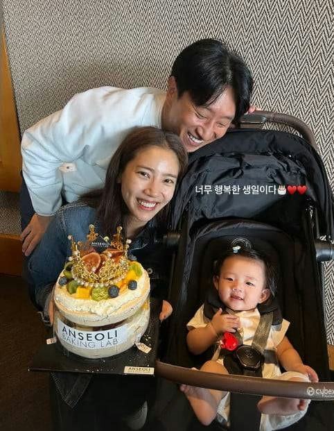 Son Dam-bi first birthday with daughter' '' 'birthday' 'cake' 'stroller' 'smiling.