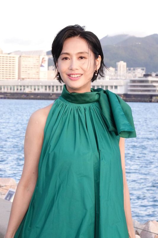 Athena Chu latest photosperson' 'woman' 'green' 'dress' 'earrings' 'waterfront.