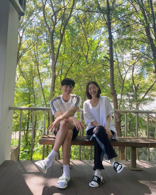 Ryu Da In Lee Chae Min relationshippeople' 'bench' 'trees' 'smiling' 'relaxed.