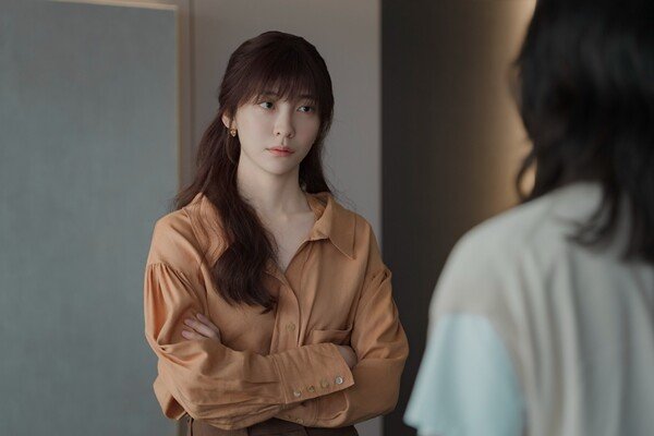 Park Ji Hyun You and Everything Else actingtwo' 'serious' 'crossed' 'arms' 'orange' 'shirt' 'indoors.