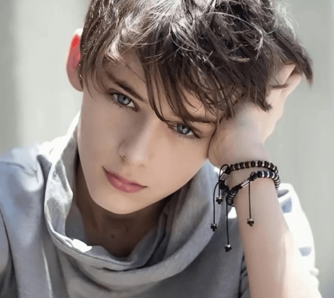 people-young boy-A-blue eyes-A-brown messy hair-B-gray cowl neck shirt-C-beaded bracelets