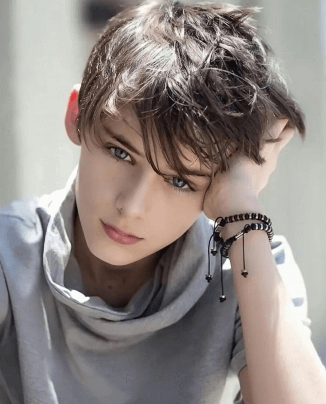 people-young boy-A-blue eyes-A-brown messy hair-B-gray cowl neck shirt-C-beaded bracelets