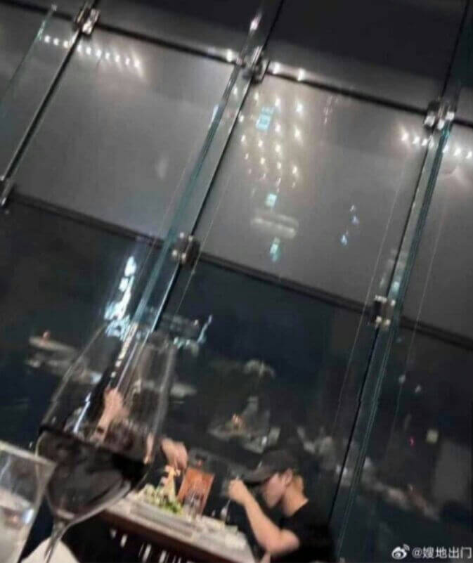 people-one person (male, wearing a black cap and black shirt)-A-dining-A-restaurant-A-night view