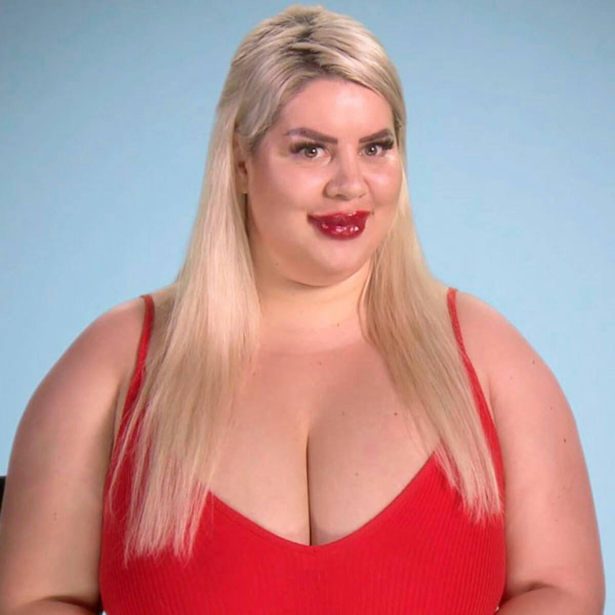 people-woman-blonde hair-red outfit-bright red lips-light blue background