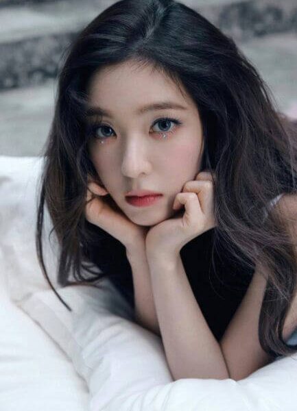 people-woman-dark hair-lying down-white pillow-glittery makeup