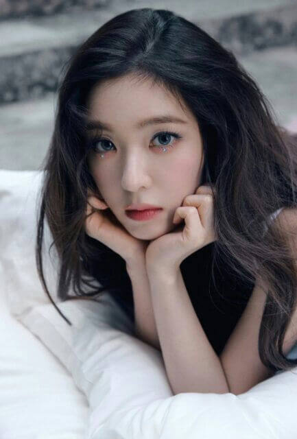 people-woman-dark hair-lying down-white pillow-glittery makeup