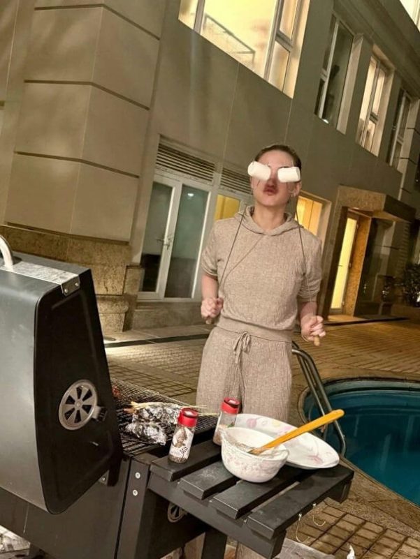 people-A-woman-A-marshmallows on eyes-B-grilling-C-by pool