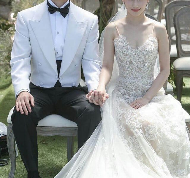 people-A-bride-and-groom-A-wedding-attire-B-holding-hands-C-outdoor-ceremony