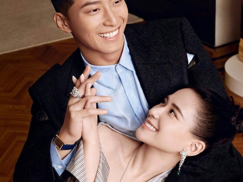people-A-smiling man-A-smiling woman-A-couple-A-holding hands-A-ELLE magazine-A-jewelry-A-elegant clothing