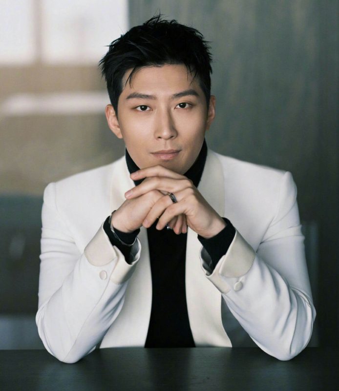 people-man-A-black turtleneck-B-white suit jacket-C-folded hands