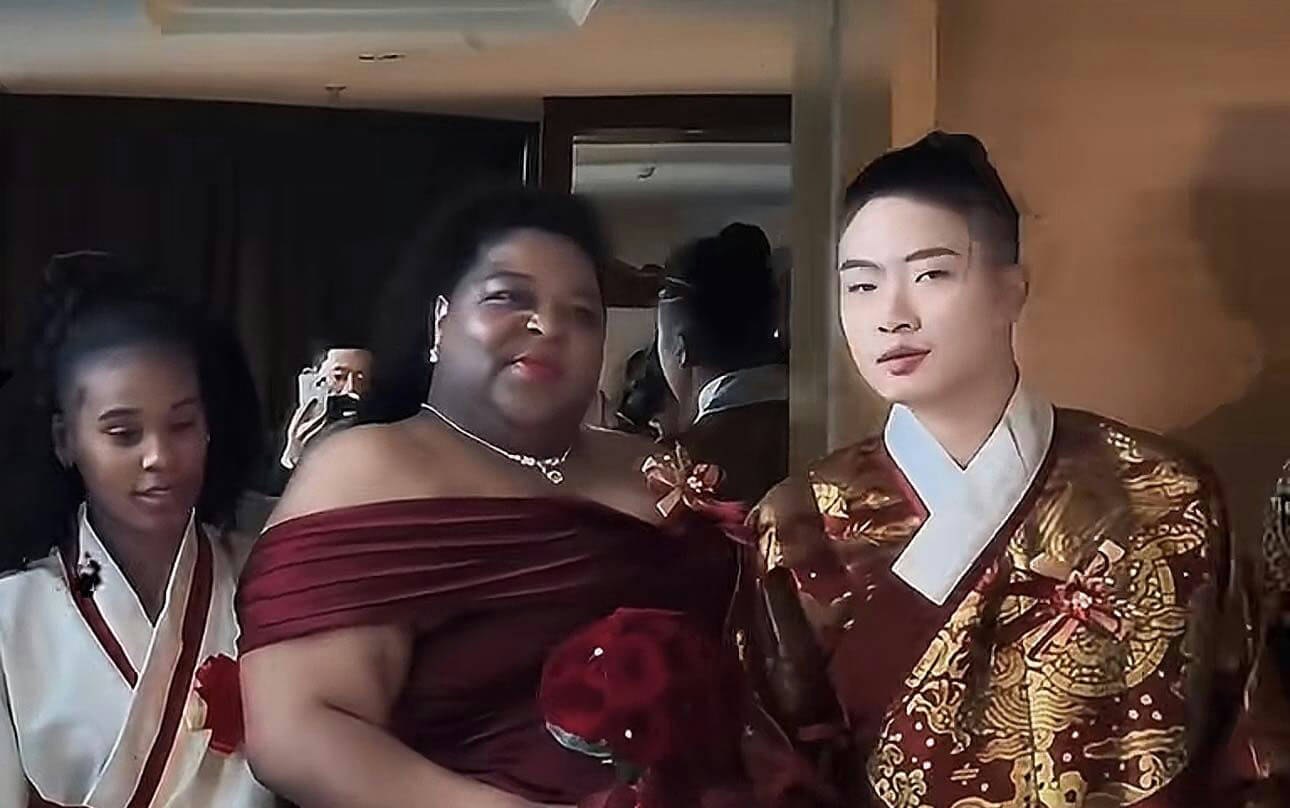 people-3-woman in off-the-shoulder maroon dress-woman in white and red traditional East Asian attire-man in ornate gold and maroon traditional East Asian attire