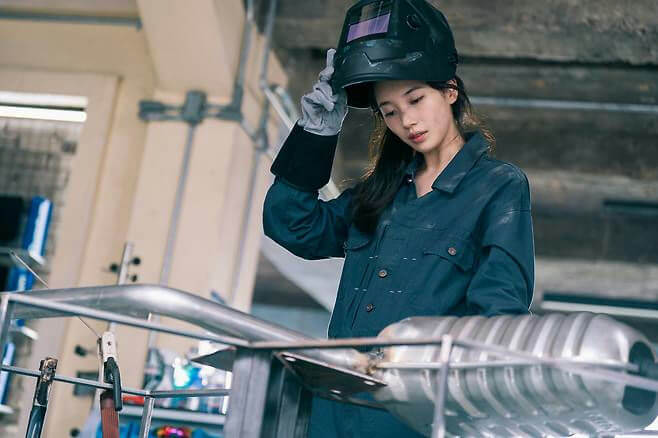 people-woman-A-welding helmet-B-dark blue workwear-C-metal fabrication