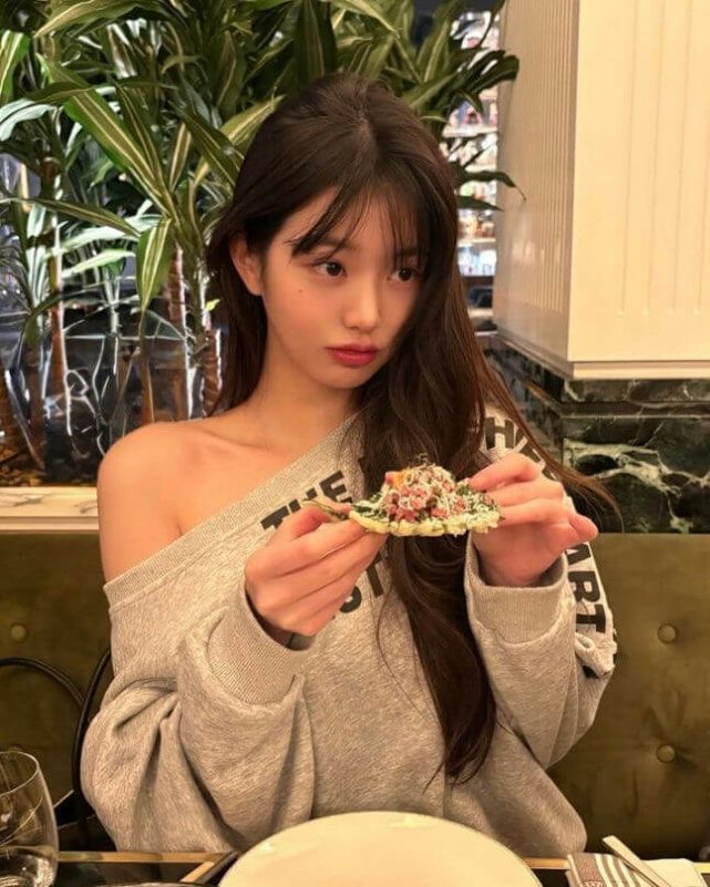 people-1-woman-A-clothing-off-the-shoulder-sweatshirt-B-action-holding-food-C-setting-indoor-restaurant