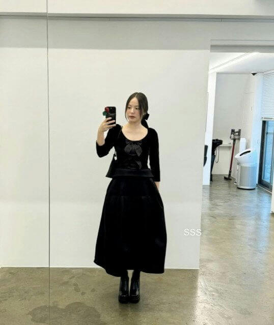 people-woman-A-all black outfit-B-velvet top with bow-C-midi skirt