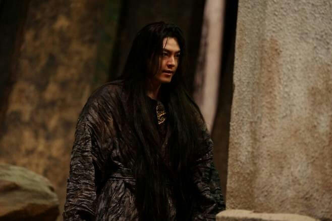 people-man-long black hair-dark robe-dramatic lighting-stone setting