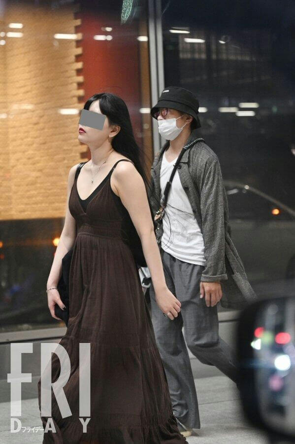 people-woman-long dark hair-woman-brown maxi dress-man-bucket hat and face mask-man-gray coat and pants
