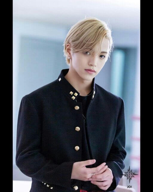 people-K-pop idol-A-blond hair-A-black jacket-A-gold buttons-A-studs on collar