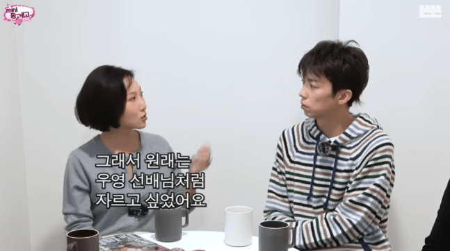 people-woman with short dark hair-interviewing-man with dark hair and striped hoodie-listening