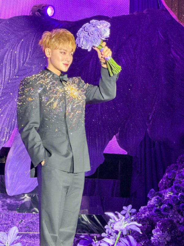 people-1-man-A-blond hair-B-holding flowers-C-sparkly jacket