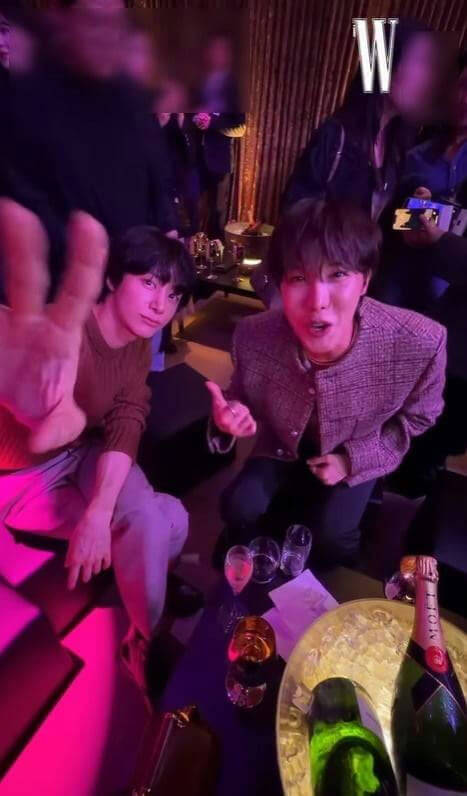 people-Two men-A-nightclub setting-A-champagne bottles-A-hand gesture
