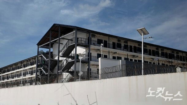 building-A-exterior view-A-modern architecture-A-barriers and barbed wire-A-solar street light